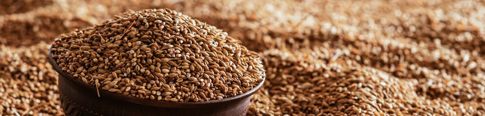 Horizontal Background A grain of wheat in a clay bowl