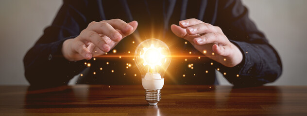 Innovation design concept. Hand holding light bulb for new idea brain storming creative inspiration.