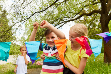 Boy reaching finish line by female friend in garden