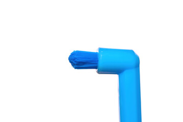 Single-tuft brush, blue toothbrush with single beam isolated on white background. New toothbrush, single-tufted brush with new bristles. Dental hygiene.