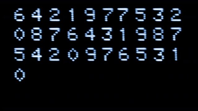 Numbers and code written on computer screen
