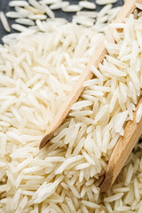 raw basmati rice on a black wooden background