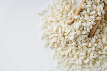 arborio rice for risotto on a white acrylic background