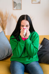 young woman blowing her nose and mouth