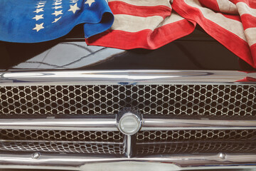 Classic black car with a vintage American flag on the motor hood
