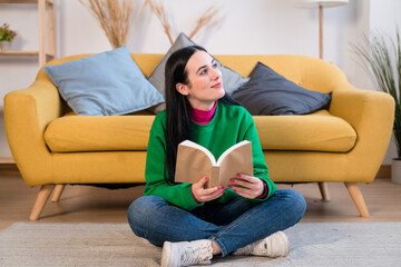 Cheerful woman with book at home