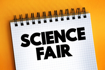 Science fair - competitive event, hosted by schools worldwide, text concept on notepad