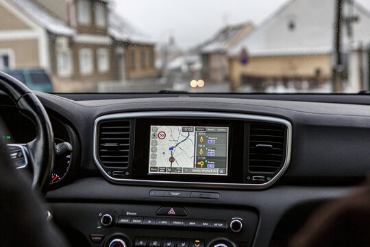 Ckyne, Czech Republic, Jan 28 2023: Navigation through foreign countries, a satnav navi system in a KIA car helps to orientate on street at czechia at a rainy day