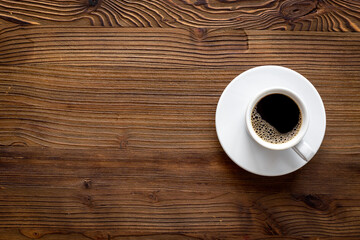 White cup of hot black coffee top view. Coffee break time concept