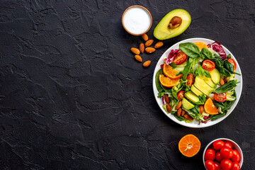 Bowl full of healthy vegetarian salad with avocado and tomatoes