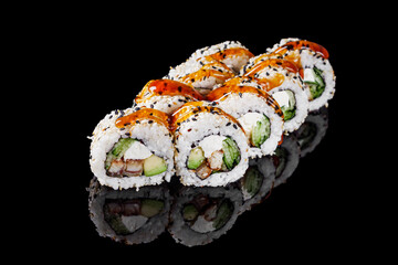 sushi roll with sesame avocado cucumber eel and Philadelphia cheese on a black mirror background