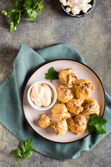 Vegetarian cauliflower buffalo wings and sauce on a plate on the table. Top and vertical view