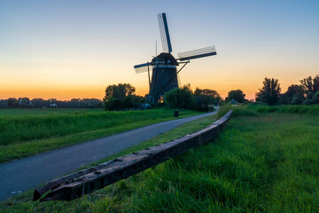 Photo of a spare part of the blades of this mill in Stompwijk (Molendriegang Stompwijk), the Netherlands, lying in the grass just after sunset