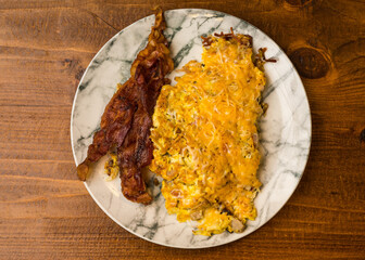Scrambled eggs with cheese and bacon