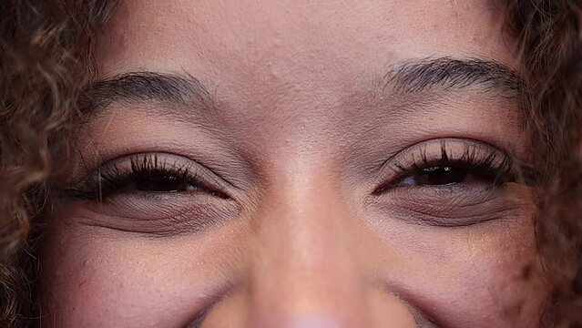 Close-up eyes of young beautiful african american model looking at the camera. Girl with big eyes. 4k