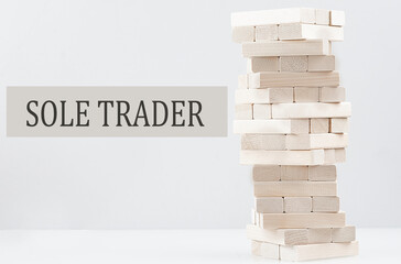 SOLE TRADER text with wooden block stack on white background , business concept