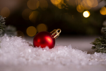 red christmas ball on snow