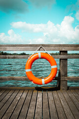 orange lifebuoy on the pier - obrazy, fototapety, plakaty