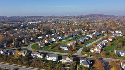 Fototapeta na wymiar Aerial view row of two-story houses in upscale residential neighborhood with downtown Rochester skylines and Pinnacle Hill background in Rochester, Upstate New York
