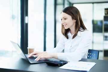 Business planning, portrait of a business woman using a computer to audit financial statements and marketing