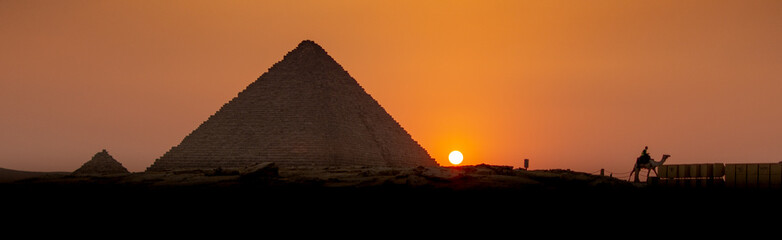 Panoramic photograph of the sunset over the pyramid of Menkaure with camel