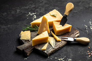 Piece of Parmesan cheese and cheese knife on a wooden background. Traditional Italian cheese. place for text, top view