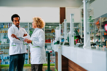 Fototapeta premium Pharmacists working together with digital tablet.