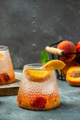 Refreshing summer homemade non-alcoholic cocktails, drinks peach cocktail with ice cubes, and mint in glass. Freeze motion splash drops
