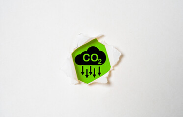 CO2 reducing icon on green background and white punch for decrease CO2 or carbon dioxide emission...