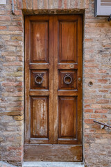 Fototapeta na wymiar Walking Urbino city streets. Close up view of beautiful ancient wooden door