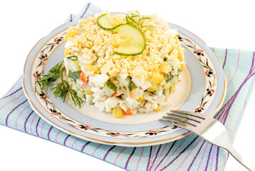 On a blue plate, a freshly prepared salad for the festive table with crab sticks, sweet corn, fresh cucumber, cheese, dill.