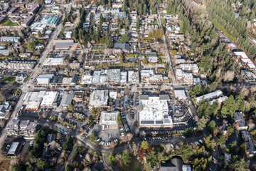 Aerial view of Bainbridge Island City  in Kitsap County, located in the Puget Sound west of Seattle with old and modern buildings, harbor and mountains in the background