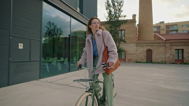young attractive woman cycling urban cruiser bike at the end of the day after work. hipster woman enjoying romantic bike ride
