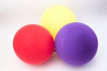 Three inflated balloons with the red, yellow and purple colors of the republican flag in Spain