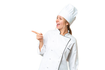 Young chef woman over isolated chroma key background pointing finger to the side and presenting a product