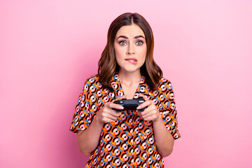 Photo portrait of lovely young lady bite lips playstation confused lose level wear trendy print outfit isolated on pink color background