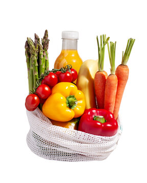 Isolated raw colorful fresh vegetables in white mesh bag  in hard light. Healthy eating, eco friendly grocery shopping concept.