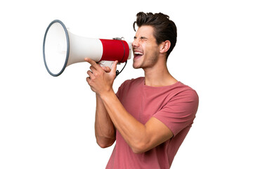 Young handsome caucasian man over isolated background shouting through a megaphone - obrazy, fototapety, plakaty
