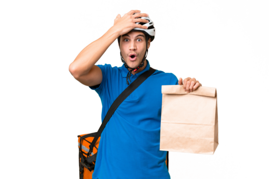 Young caucasian man taking a bag of takeaway food over isolated background with surprise expression