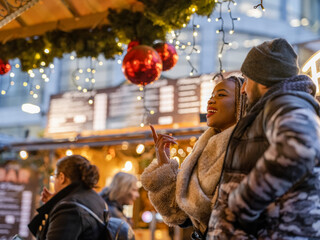 Smiling young couple at Christmas market