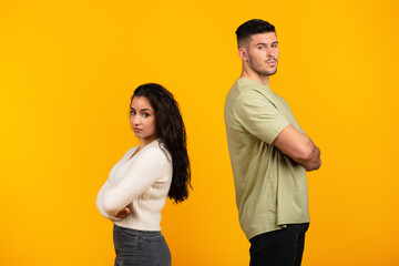 Fototapeta premium Sad offended young middle eastern woman ignores boyfriend in casual with crossed arms, think about divorce