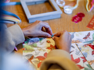 Woman making decorations at home table