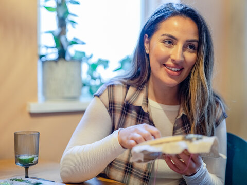 Smiling Woman Embroidering At Home