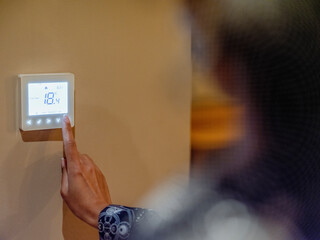 Woman adjusting home heating