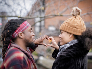 Couple making heart sign
