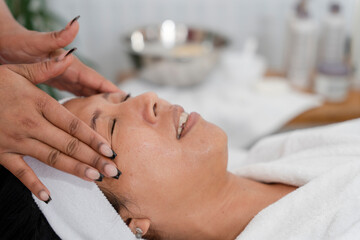 Fototapeta na wymiar Close-up of woman having face massage at spa