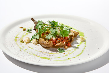 Baked eggplant with cheese on white table with harsh shadows. Aesthetic italian food - baked aubergine on white plate. Stuffed eggplant in minimal style. Stuffed aubergine in vegan menu.