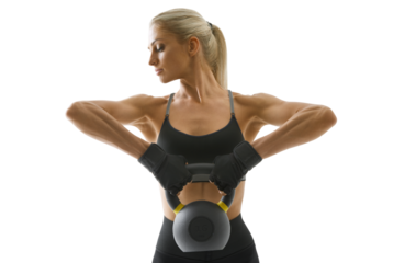 Sportswoman in sportswear, gloves, black top and leggings trains arm muscles. Kettlebell workout.