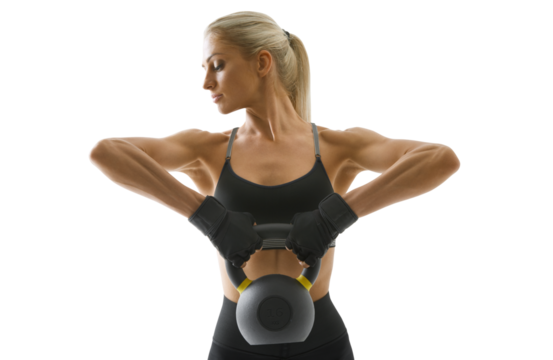 Sportswoman in sportswear, gloves, black top and leggings trains arm muscles. Kettlebell workout.