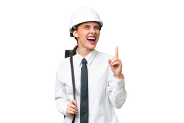 Young architect woman with helmet and holding blueprints over isolated background pointing up a great idea